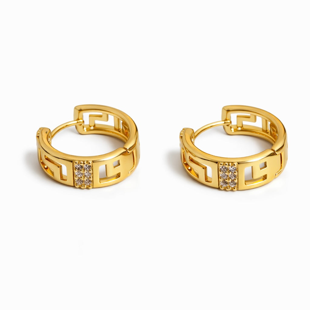 Gold plated Greek key huggie hoop earrings with cubic zirconia accent, 1.8 cm diameter, 6 mm width.

