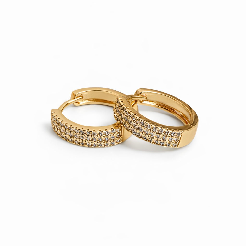 Gold plated pavé huggie hoop earrings with cubic zirconia, 1.7 cm diameter, 4 mm thickness.