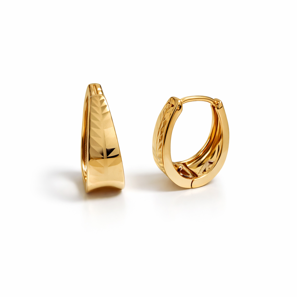 Gold plated textured huggie hoop earrings with faceted surface, 2.3 cm height, 9 mm width.